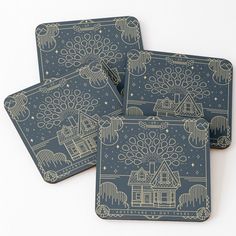 three coasters with designs on them sitting next to each other