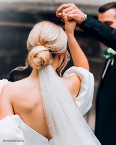 a bride and groom are getting ready to walk down the aisle