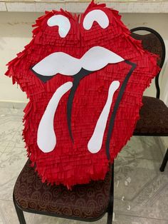 the rolling stones'tongue is made out of toilet paper and sits on a chair