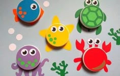 four magnets with different colored sea animals on them