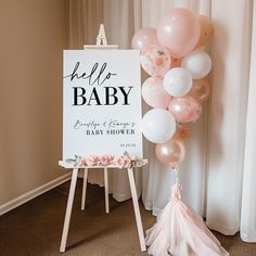 a baby shower sign with balloons and a tassel