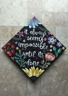 a decorated graduation cap that says it always seems impossible until it's done one