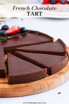 a chocolate tart is cut into slices on a cutting board