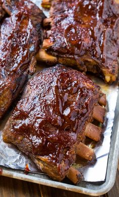 ribs covered in bbq sauce sitting on top of tin foil