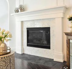 a fireplace in a living room with white walls