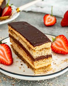 a piece of cake on a plate with strawberries