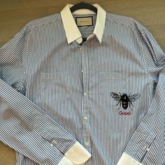 Never Worn. Blue And White Stripes. White Collar And White Sleeves. Signature Black Bee On Pocket With Red Gucci Writing. Neck 17.5 Shirt 44 Size. Retail $850 Gucci Shirts Men, Gucci Shirts, White Sleeves, Black Bee, Gucci Men, White Collar, Mens Shirt Dress, White Stripe, Blue White