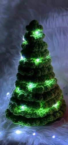 a crocheted christmas tree with green lights