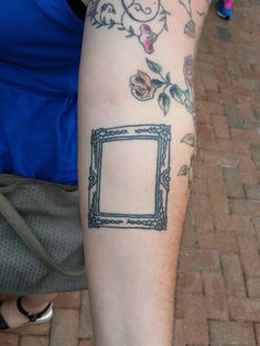 a person with a frame tattoo on their arm