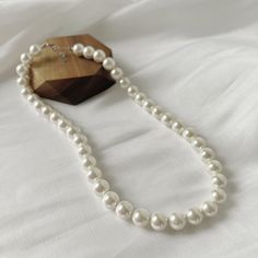 The Classic Pearl Necklace gives off ultra feminine vibes. Every girl needs one in their collection. Made up of real freshwater pearls Perfect for daily wear or on a night out. Material: Freshwater PearlsLength: 43+3cm Tarnish Free Hypoallergenic Glazd Pouch with every order Free US shipping Easy Exchange & Return policy PRODUCT INFOThis necklace is made of Full Sterling Silver 925 material, not just plated. We added rhodium plating and our organic coating. This means the color will last for a r Classic Pearl Necklace With Pearl Chain For Parties, Elegant Pearl White Beaded Necklace With Clavicle Chain, Classic Pearl Chain Necklace For Party, Classic Pearl Necklace For Party, Trendy Pearl Necklace For Party, Formal Beaded Necklaces With Pearl Chain, Long Pearl Necklace With Pearl Charm For Party, Classic Pearl Drop Necklaces For Party, Classic Pearl Pendant Necklace For Party