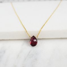 Add a touch of elegance with this handmade necklace, featuring a genuine Garnet gemstone dangling on a simple dainty chain. Choose your length for a choice to wear it as a choker or a long layered necklace. Simple, minimal, and elegant all-in-one necklace. Makes a great gift to add to any gemstone lover's collection. Perfect to gift for Christmas, Valentine's Day, Mother's Day, and more! Gemstone: Garnet Gemstone Size: 11.0 mm Gemstone Shape: Pear, Faceted Metal: 14k Gold Filled or Sterling Silv Elegant Teardrop Garnet Pendant Jewelry, Faceted Briolette Garnet Jewelry, Faceted Garnet Necklace Gift, Elegant Garnet Necklace With Faceted Beads, Faceted Garnet Red Necklace, Briolette Necklace, Long Layers, Garnet Gemstone, Layered Necklaces