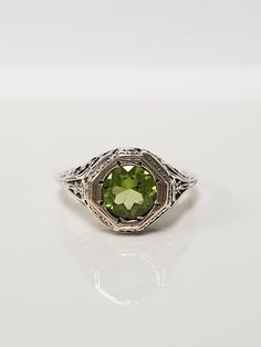 Once in a Blue Moon beautiful vintage finds. Antique Peridot Filigree Ring // Solid 925 Sterling Silver. Antique Remake. Ethical, lab created gemstone. Elegant mid-century style filigree and carving. Size: 6, 8, 9, 10 US * Message me for sizing options Weight: 2.0 g Stone: 1.0 ct (6.5 mm) Band width: 1.2 mm Free shipping, comes packaged in a ring box ready to gift! Vintage Sterling Silver Filigree Ring, Vintage Oval Filigree Ring As Gift, Vintage Filigree Ring With Gemstone As A Gift, Vintage Gemstone Filigree Ring For Formal Events, Vintage Filigree Ring With Gemstone For Formal Events, Vintage Hallmarked May Birthstone Ring, Vintage White Gold May Birthstone Rings, Vintage Filigree Ring For Anniversary, Vintage Gemstone Ring For May Birthstone