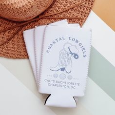 two hats and some paper on top of a white table with a brown hat in the background