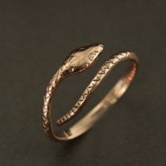 This Solid 14K Gold snake ring will surely become one of your favorite accessories! Inherently stylish, this ring is hand cast in our studio in your choice of solid 14K gold: Rose, White or Yellow. Your ring will be made to size just for you, but is also adjustable for any occasion or weather. The snake measures approximately 2mm wide by 1.5mm thick (varying along his length). And his head measures 4mm wide by about 8mm long. He coils effortlessly around your finger for a unique accessory that w Adjustable Snake Shape Promise Ring, Adjustable Snake Ring Gift, Adjustable Snake-shaped Symbolic Rings, Symbolic Adjustable Snake Ring For Anniversary, Symbolic Adjustable Snake Ring Gift, Adjustable Symbolic Snake Ring Gift, Adjustable Snake Symbolic Ring, Adjustable Symbolic Snake Ring, Unique Adjustable Snake Ring For Anniversary