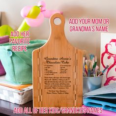 a wooden cutting board sitting on top of a desk next to other office supplies and personalized items