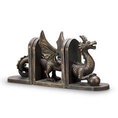 a metal bookend with two dragon figurines on it's sides and one is