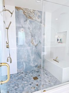 a bathroom with a walk in shower next to a bath tub