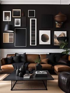 a black and brown living room with pictures on the wall, leather couches and coffee table