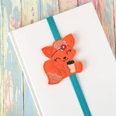 a card with an embroidered bear holding a cup of coffee on it's side