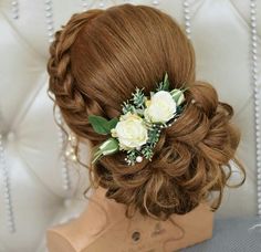 a woman with flowers in her hair sitting on a chair