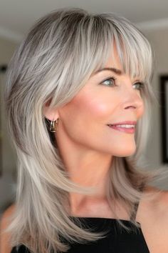 Layered Shoulder-Length Cut With Bangs Hairstyle on smiling older woman with silver gray hair. Shoulder Length Gray Hair With Bangs, Silver Hair With Bangs, Gray Hair With Bangs, With Bangs Hairstyle, Wash And Wear Haircuts, Silver Gray Hair, Grey Hair And Makeup, Shoulder Length Hair With Bangs