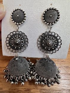 These Oxidized Jhumka Earrings are the perfect addition to any outfit. Crafted with precision, the oxidized finish gives them a unique charm. Made with high-quality materials, these earrings are durable and comfortable to wear. Elevate your style with these elegant and versatile earrings. Nickel Free Metal Danglers For Festive Occasions, Festive Nickel-free Metal Danglers, Nickel-free Metal Danglers For Festive Occasions, Metal Chandbali Danglers For Pierced Ears, Bohemian Drop Jhumkas In Metal, Traditional Oxidized Finish Jhumkas Drop Earrings, Traditional Oxidized Jhumkas Drop Earrings, Traditional Oxidized Drop Earrings Jhumkas, Metal Jhumkas For Festival, Pierced Ears