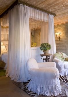 a bedroom with white furniture and curtains on the windowsills, along with a zebra print rug