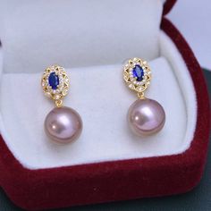 Make a lasting impression with the 11-12mm Freshwater Pearl & Blue Gem Cubic Zirconia Earrings-. These gorgeous earrings are set in a vintage-inspired silver alloy setting and feature shimmering white freshwater pearls and blue Cubic Zircoina gems. The combination of these two elements will bring a touch of elegance to any look, making them perfect for any occasion. Showcase your style and sophistication with this timeless piece from House of Pearls. This popular earrings design features AAAA qu Blue Pearl Earrings For Formal Occasions, Blue Pearl Earrings Fine Jewelry For Formal Events, Blue Pearl Earrings For Formal Events, Luxury Blue Pearl Earrings For Anniversary, Classic Blue Round Pearl Earrings, Blue Round Pearl Earrings For Anniversary, Classic Blue Pearl Drop Earrings, Classic Blue Pearl Earrings In Sterling Silver, Blue Classic Sterling Silver Pearl Earrings