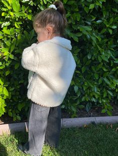 Our bestseller that keeps selling out! Features a blanket stitch detail around collar, pockets, sleeves and bottom of the coat. Fit is oversized and can be worn over layers. Drop shoulder and slight bell at the sleeves. The lining is self and is the backside of the faux sherpa fleece fabric. Functional button closures. We recommend taking your child's normal size in this jacket. *Model is 2.5 years old and is wearing the size 2Y Cozy Cream Outerwear With Ribbed Cuffs, Cute Oversized White Outerwear, Cute White Outerwear With Fleece Lining, Cute Cream Outerwear, Cute White Outerwear For Fall, Cute Cream Long Sleeve Outerwear, Winter Long Sleeve Outerwear For Playtime, Cute Warm White Outerwear, Fleece-lined Outerwear For Playtime In Fall