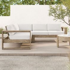 a white couch sitting on top of a wooden table