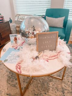 a coffee table with a mirror ball on it and some cards in front of it