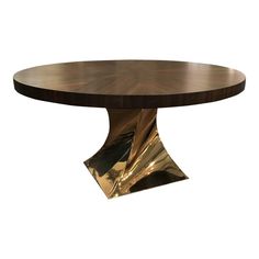 a round wooden table with gold leaf accents