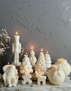 a group of white candles sitting on top of a table