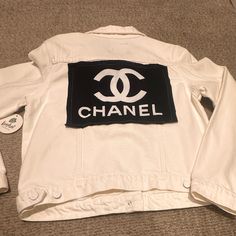 White Denim Jacket With Chanel Patch In Black Sewn On Back Of Jacket Never Worn Chic Cotton Denim Jacket For Streetwear, Chic Cotton Streetwear Outerwear, Chic Cotton Outerwear For Streetwear, Trendy White Denim Jacket For Streetwear, Chic White Denim Jacket, White Denim Outerwear For Fall, White Fitted Denim Jacket For Fall, Chic White Cotton Outerwear, Chic White Outerwear For Streetwear