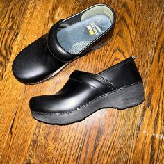 Like New Used Once Classic Black Clogs With Flat Heel, Classic Black Flat Heel Clogs, Black Clogs With Leather Sole For Formal Wear, Black Leather Sole Clogs For Formal Occasions, Black Leather Sole Clogs For Formal Wear, Black Formal Clogs With Leather Sole, Formal Black Slip-on Clogs, Modern Black Round Toe Clogs, Black Round Toe Clogs For Workwear