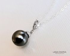 Dark Grey Charcoal Colored Pearl Drop Silver Pendant Necklace with .925 Sterling Silver Chain. PLEASE READ ITEM DESCRIPTION and  SHOP POLICIES before placing your order, and contact me with any questions! CHAIN is 18 inches (45.7cm) long. PENDANT is about 0.86 inch (2.2cm) long including bail. MATCHING EARRINGS: https://www.etsy.com/listing/741839085/dark-grey-pearl-earrings-grey-pearl-drop?click_key=65ac9cbe46a4ad2ec0ea34d8b2f3e88e02d0ee51%3A741839085&click_sum=ce7a638d&ref=shop_home_active_1&sts=1 NECKLACES SECTION: https://www.etsy.com/shop/LanaChayka?ref=simple-shop-header-name&listing_id=880970583§ion_id=17026331&sort_order=date_desc BRIDAL NECKLACES SECTION: https://www.etsy.com/shop/LanaChayka?ref=simple-shop-header-name&listing_id=880970583§ion_id=11638944&sort_order=date_desc Simp Bridal Necklaces, Grey Jewelry, Grey Pearl Earrings, Grey Pearl Necklace, Single Pearl Necklace, Women Necklaces, Gray Jewelry, Single Pearl, Wedding Pendant