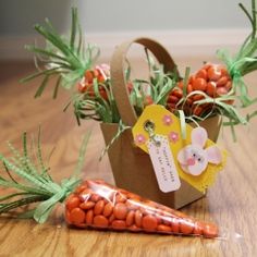 there is a carrot next to a paper bag on the floor with flowers in it