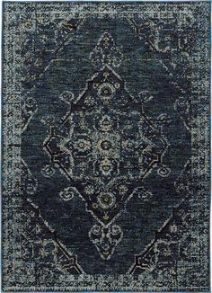 a blue rug with an ornate design on the front and back side, in various colors