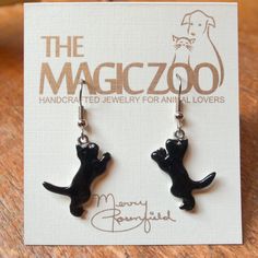 "These enamel black cat earrings make a fantastic gift for the cat lover! Do you happen to think black cats bring good luck! I do, and why not? These handcrafted and hand painted earrings are each 1\" tall by 3/8\" wide and come on stainless steel ear wires. By the way, they would be wonderful to wear on Halloween! When I create a pair of enamel earrings, they are usually created mirror-image style, with the right and left earring facing each other. Because of the hand crafted nature of my work, Black Cat Ears Jewelry With Cat Design, Novelty Black Cat Design Jewelry, Black Cat Design Novelty Jewelry, Novelty Black Jewelry With Cat Design, Black Novelty Jewelry With Cat Design, Handmade Black Enamel Earrings, Black Cat Ears Jewelry For Gifts, Black Cat Ears Jewelry As A Gift, Black Enamel Nickel-free Earrings