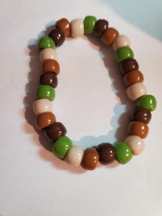 Stretchy string with nature assorted colors, pony beads were used. Earth tone colors of green, brown, tan and beige. Pony Bead Bracelets, Earth Tone Colors, Pony Beads, Green Brown, Bead Bracelet, Cottage Core, Green Colors, Halloween Shopping, Jewelry Bracelets