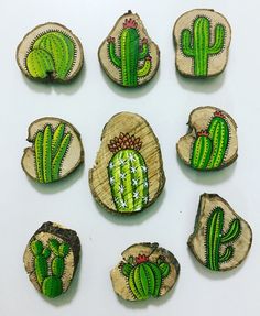 six wooden slices with green cactus designs on them