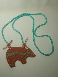 Handmade Leather Bear Amulet Necklace Handmade Adjustable Brown Turquoise Necklace, Southwestern Style Hand Tooled Necklace As Gift, Handmade Brown Necklaces For Everyday Use, Handmade Turquoise Necklaces For Everyday Use, Artisan Brown Turquoise Necklace Hand-strung, Handmade Brown Necklace For Everyday, Handmade Turquoise Necklace For Everyday Use, Artisan Beaded Brown Turquoise Necklace, Adjustable Brown Beaded Amulet Necklace