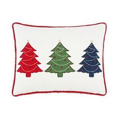 three christmas trees embroidered on a white pillow