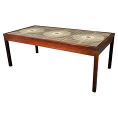 a wooden table with tile top and legs