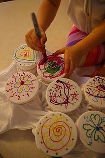 a child is drawing on some paper with colored crayons