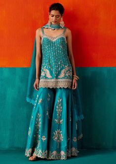 Radiate charm in this turquoise kurta, adorned with floral embroidery highlighted by various embellishments. Paired seamlessly with a complementing sharara, this ensemble is a perfect blend of grace and style, ideal for adding a touch of elegance to your special occasions. Suits For Women Indian, Embroidered Sharara, Kurta Sharara Set, Kurta Sharara, Indian Princess, Traditional Indian Outfits, Embroidery Suits Design, Dupion Silk, Sharara Set