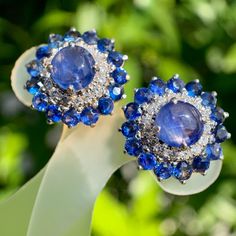 - Statement sapphire diamond earring  - Burmese natural vivid blue cabochon sapphire (2pcs)(2.30ct), semi round mix cut sapphire (32pcs)(2.80ct) Total sapphire weight (5.10ct) Brilliant round cut diamond (30pcs) - Set with 18k yellow gold (7.913g) Luxury Sapphire Diamond Earrings With Brilliant Cut, Luxury Blue Diamond Earrings With Prong Setting, Luxury Tanzanite Earrings With Gemstone, Luxury Tanzanite Gemstone Earrings, Blue Tanzanite Earrings With Prong Setting, Blue Tanzanite Brilliant Cut Earrings, Brilliant Cut Tanzanite Blue Earrings, Dazzling Blue Diamond Earrings, Blue Sapphire Diamond Earrings With Brilliant Cut