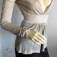 Nwt Vintage Gianfranco Ferre Long Sleeved Deep Plunged V-Neck Peplum Knit Top. Sleeves Have Ruching On Cuffs. Material Is Viscose And Nylon. Feels Like Linen Knit. Would Need To Wear A Bralette Or Camisole Underneath. Oatmeal Color. Size Small. Approx Measurements Laying Flat And Relaxed: Waist 23" (Stretches To About 28", Length From Shoulder 23". Made In Italy * Please Do Not Use My Photos Without Permission Elegant Fitted V-neck Cardigan, Elegant Stretch V-neck Cardigan, Elegant Cream V-neck Cardigan, Feminine Fitted Long Sleeve Cardigan, Fitted Long Sleeve Feminine Cardigan, Chic Taupe V-neck Top, Elegant Stretch Fine Knit Cardigan, Cream V-neck Fine Knit Cardigan, Feminine Fitted V-neck Cardigan