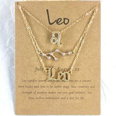 two necklaces with the name leo and an astro sign on them, sitting in front of a card