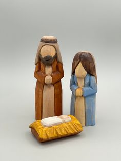 three wooden figurines sitting next to each other